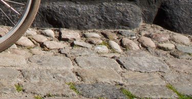 Wheel and bumpy cobblestones.