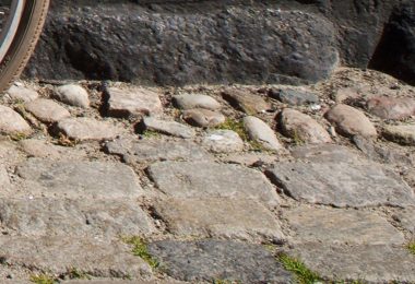 Wheel and bumpy cobblestones.